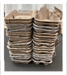 Stack of collected egg cartons for the Food Pantry