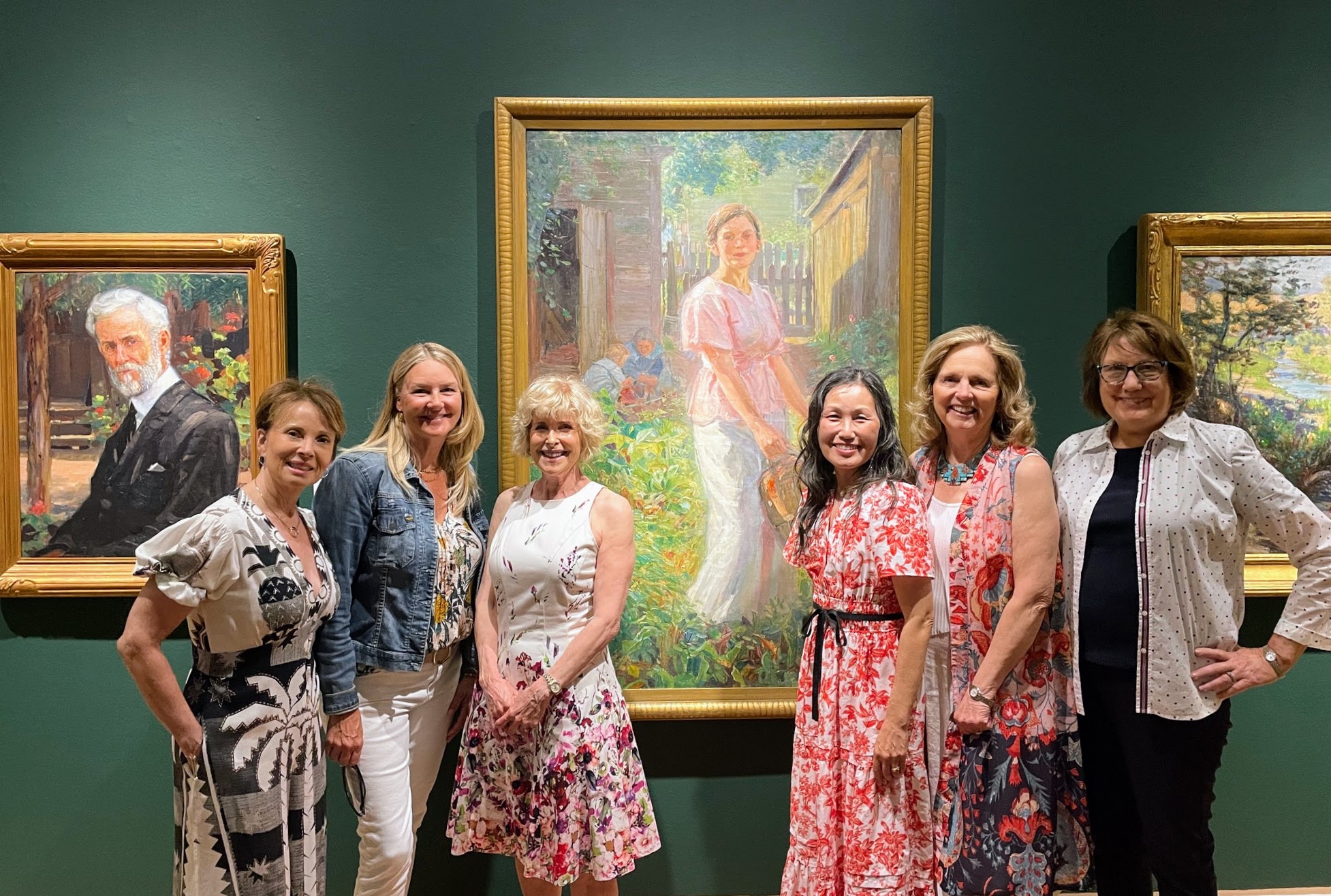 Board members posing in front of sponsored painting in Joeseph Kleitsch exhibit